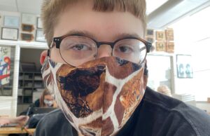 Ethan Miller models a homemade mask, which is one way to help the community during COVID.